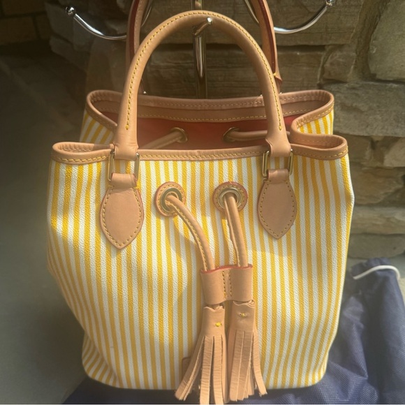 Dooney & Bourke Handbags - Sold! Dooney & Bourke Yellow and Tan Bag with Tassel Accents in dust bag